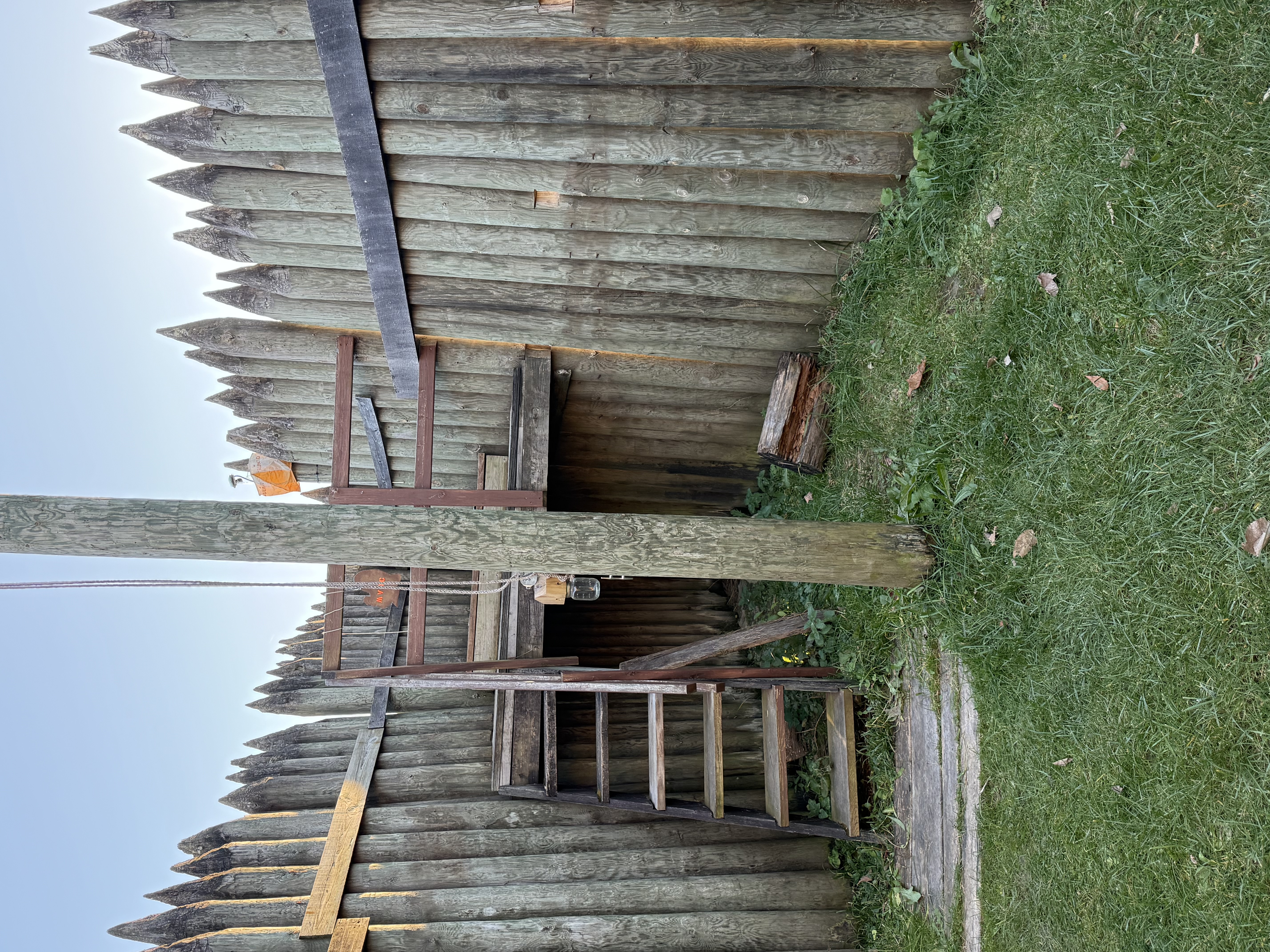 Inside the fort, showing a wooden staircase leading to a guard platform.